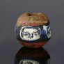 Ancient Roman glass bead with face pattern
